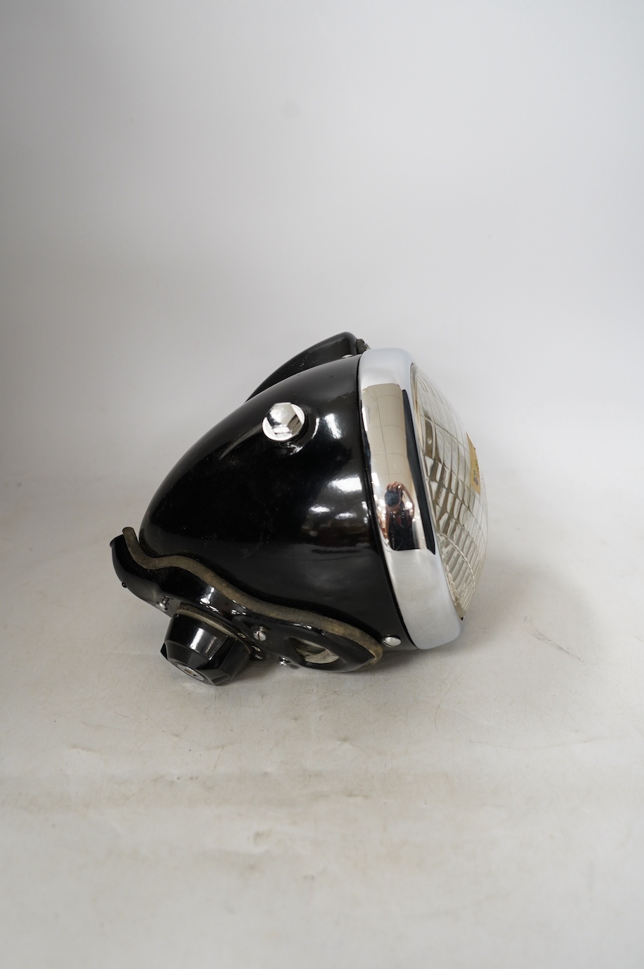 A boxed and apparently unused Lucas 575 motorcycle headlamp, in its original card box with the inner card packing pieces. Condition - fair to good, fading and wear to the box